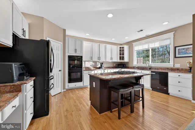 a kitchen with stainless steel appliances granite countertop a stove and cabinets