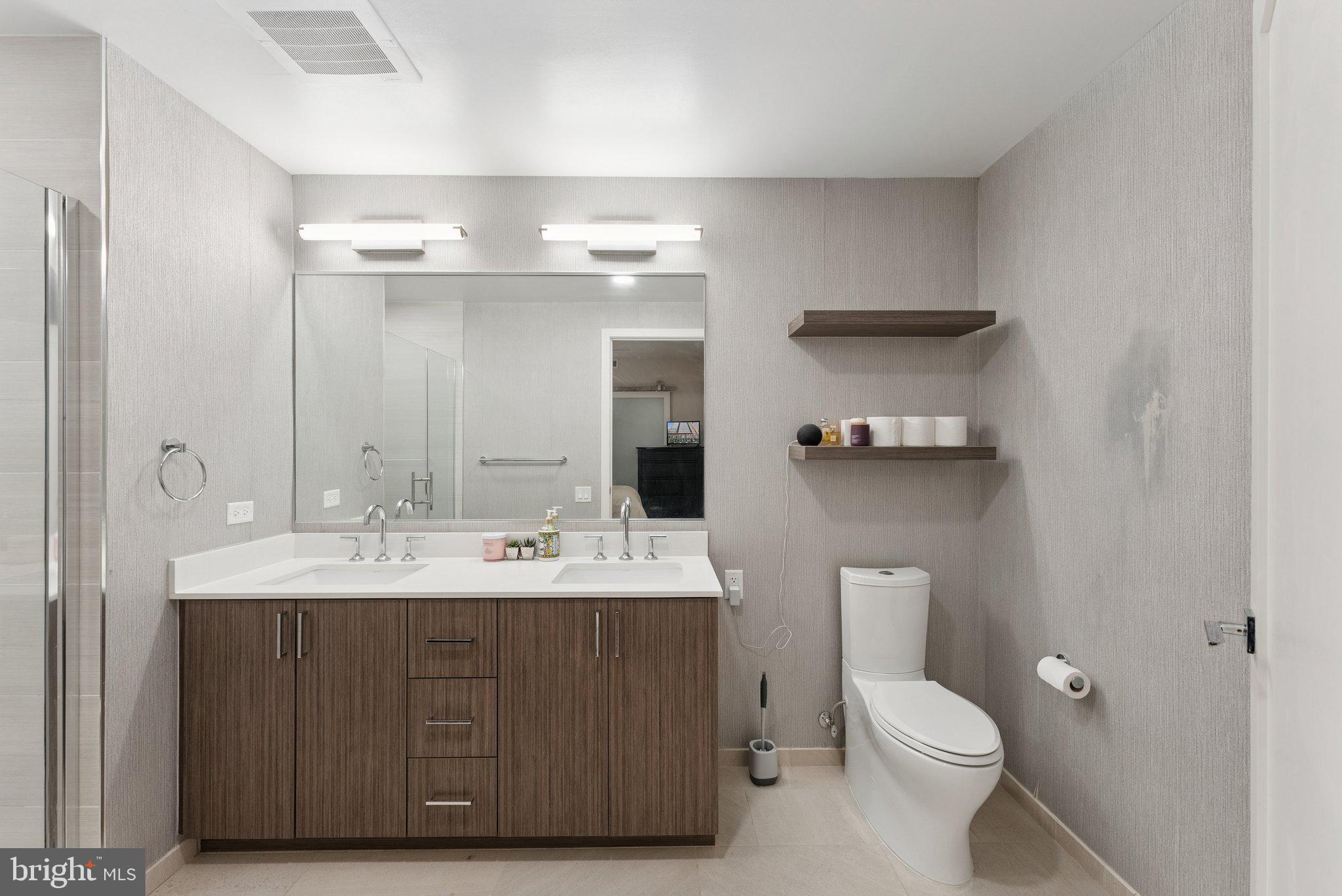 1211 Van Street Southeast, Unit 913 Washington, DC 20003 - Photo 14 of 38 a bathroom with a toilet a sink and mirror