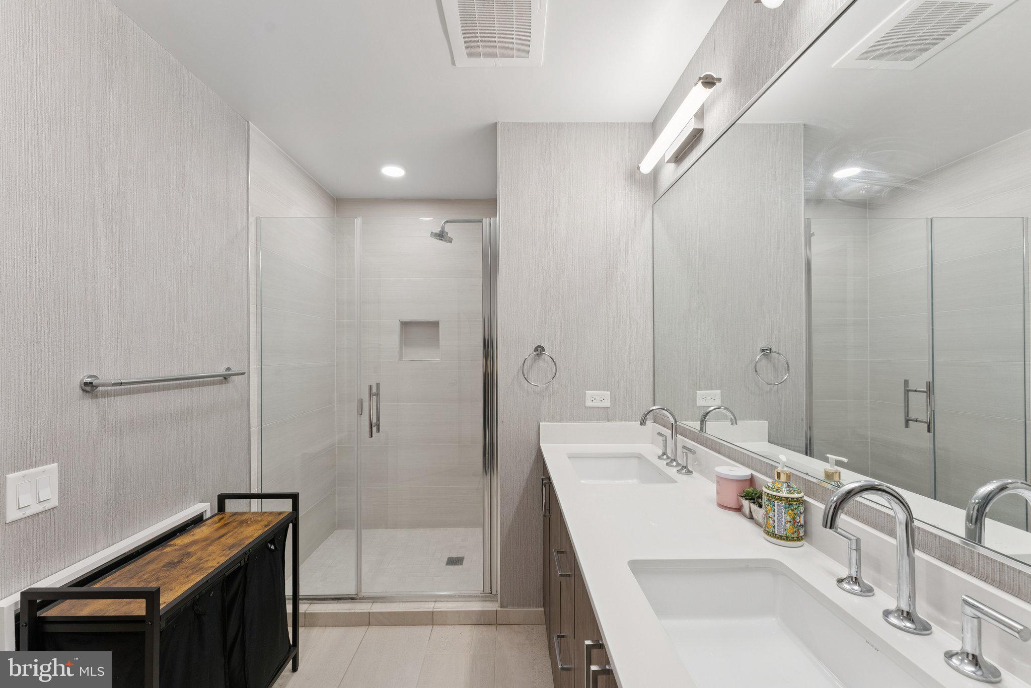 1211 Van Street Southeast, Unit 913 Washington, DC 20003 - Photo 15 of 38 a bathroom with a sink a shower and a mirror