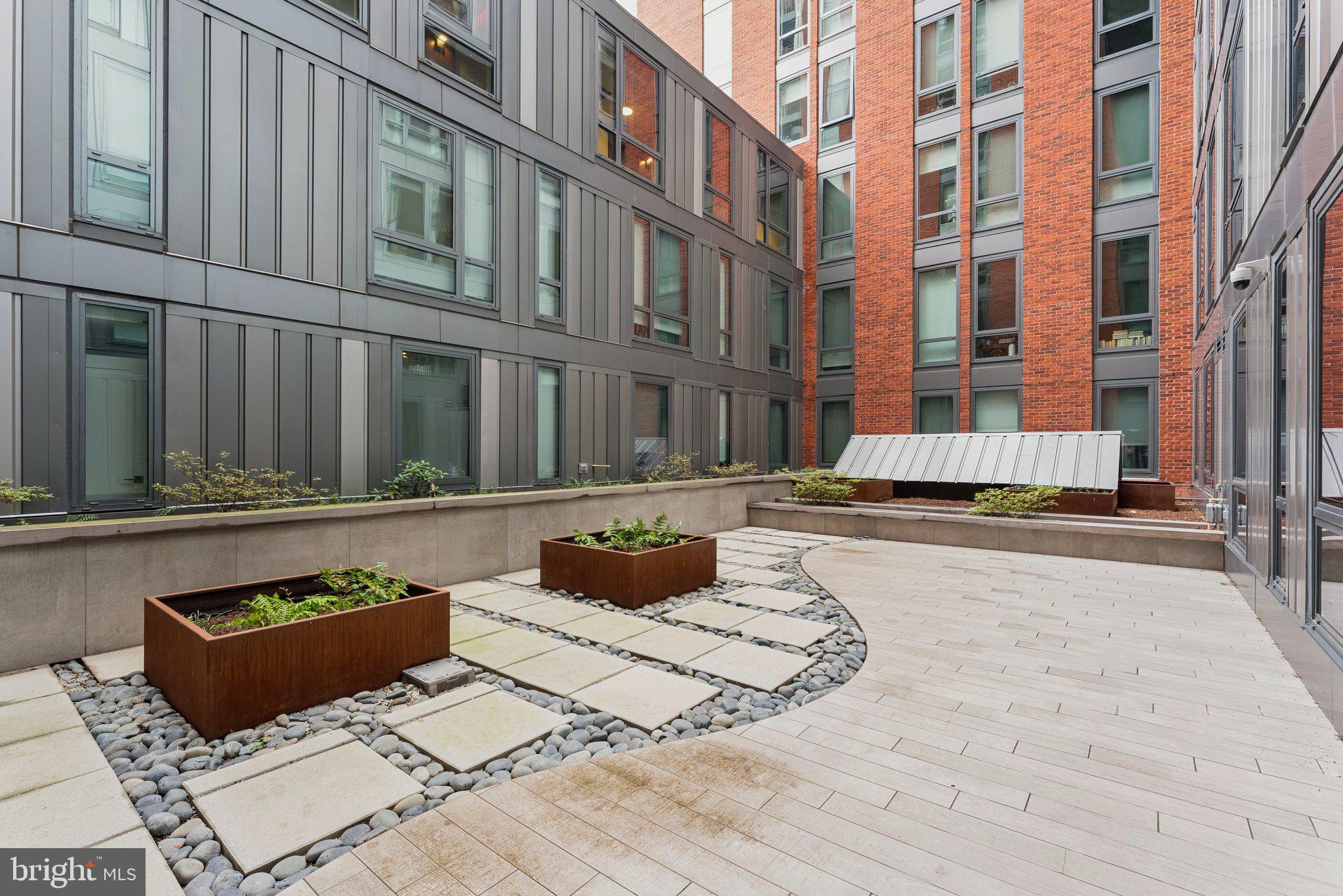 1211 Van Street Southeast, Unit 913 Washington, DC 20003 - Photo 26 of 38 a view of a building with a outdoor sitting space