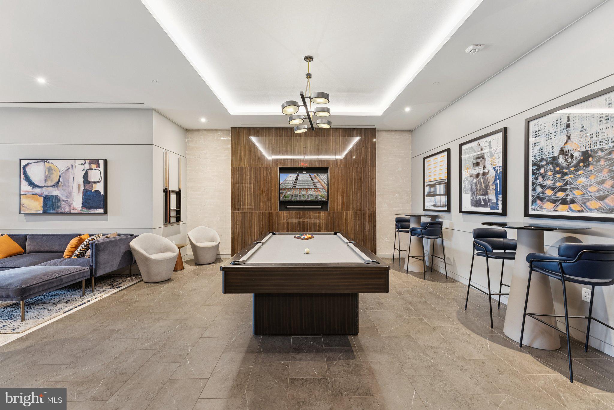 1211 Van Street Southeast, Unit 913 Washington, DC 20003 - Photo 35 of 38 a living room with furniture a chandelier and a large window