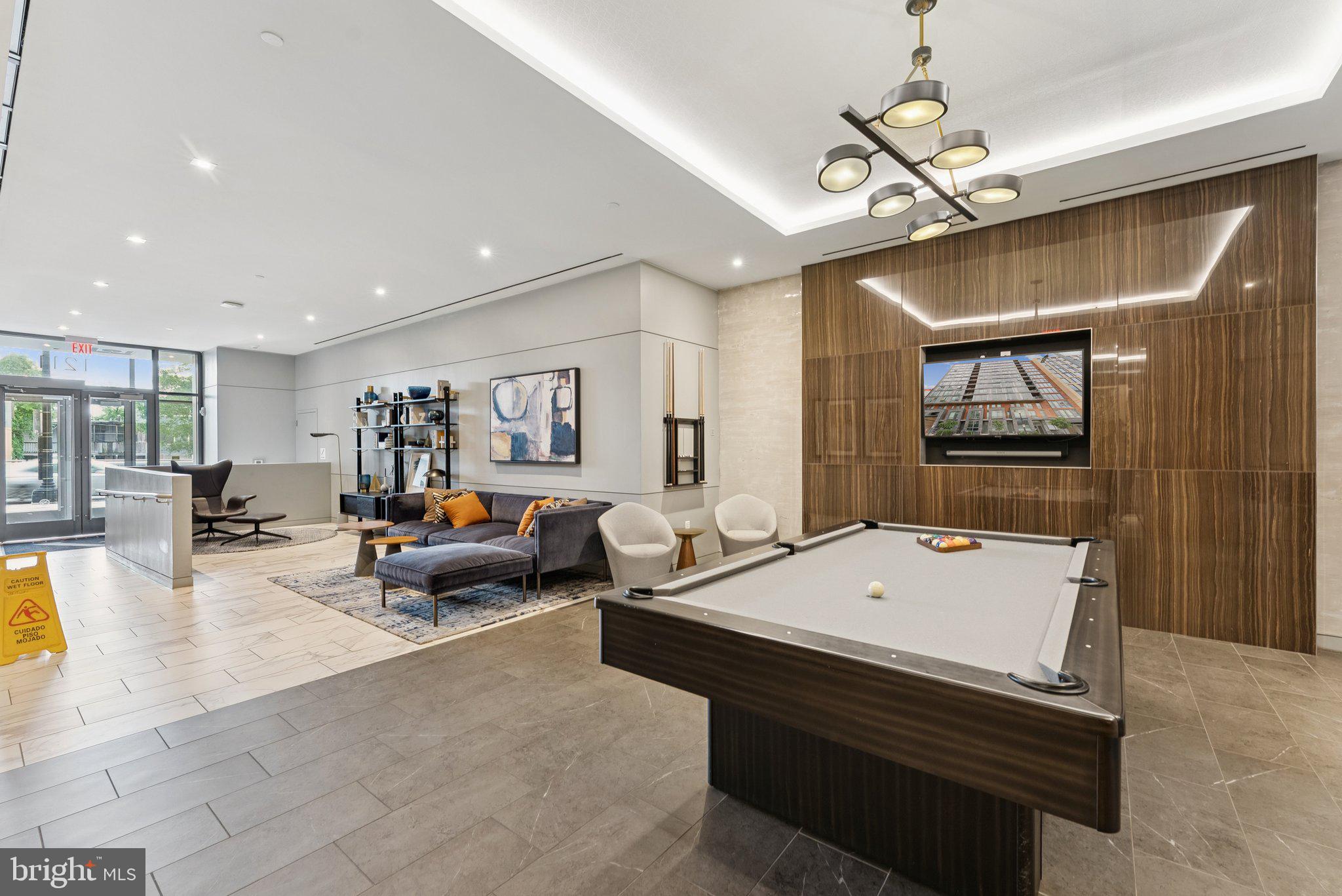 1211 Van Street Southeast, Unit 913 Washington, DC 20003 - Photo 36 of 38 a living room with furniture and a flat screen tv