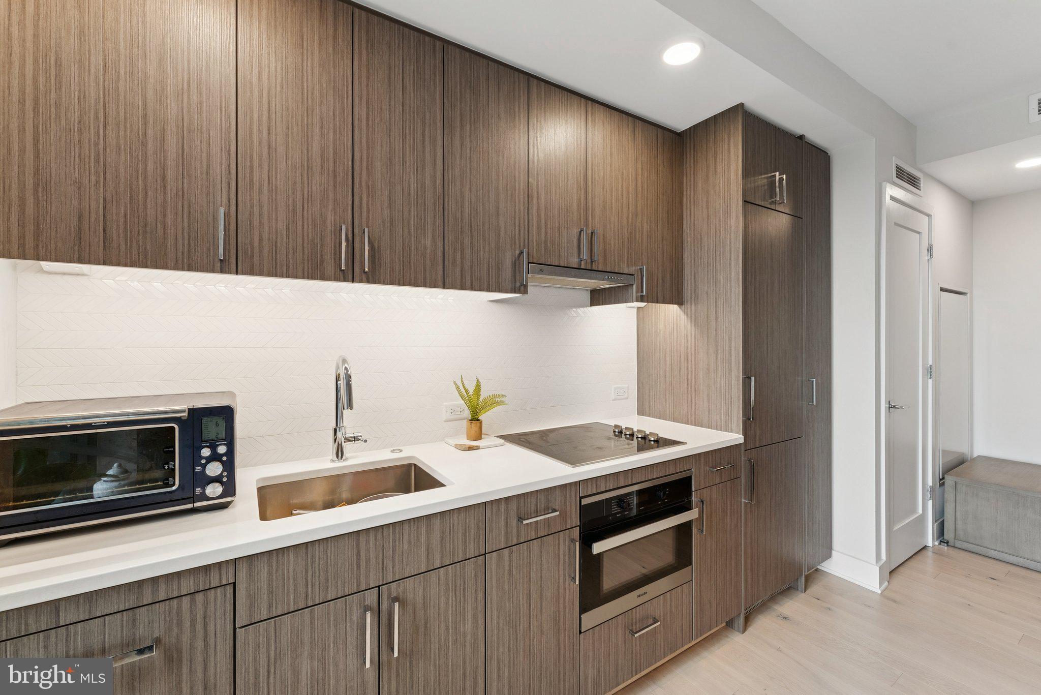 1211 Van Street Southeast, Unit 913 Washington, DC 20003 - Photo 8 of 38 a kitchen with a sink and a microwave