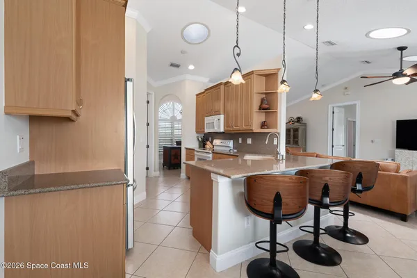 a kitchen with stainless steel appliances granite countertop sink and refrigerator