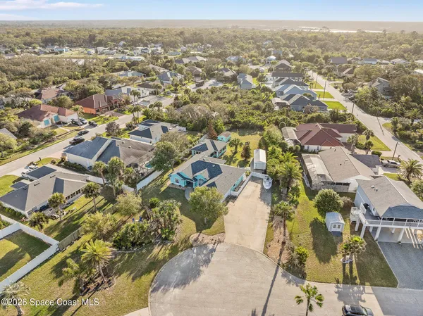 an aerial view of residential houses with outdoor space