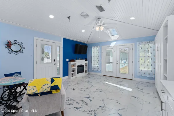 a bathroom with a granite countertop sink a toilet and a mirror