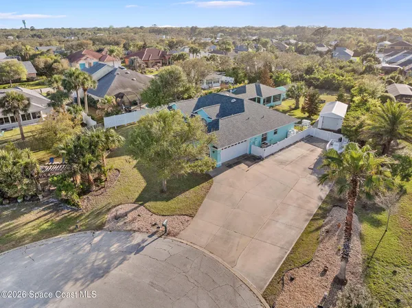 an aerial view of a house with a yard
