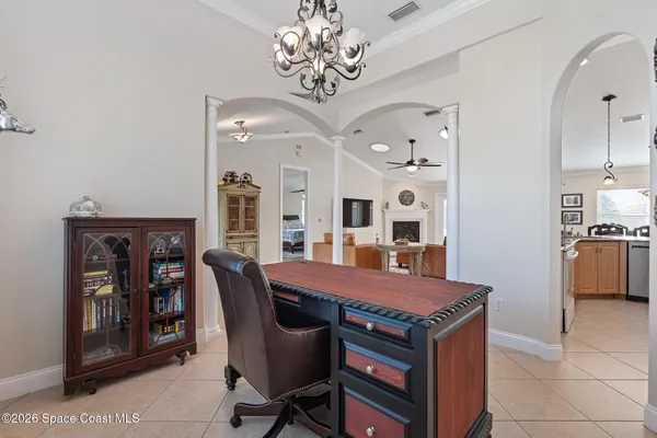 a living room with furniture a clock and a fireplace