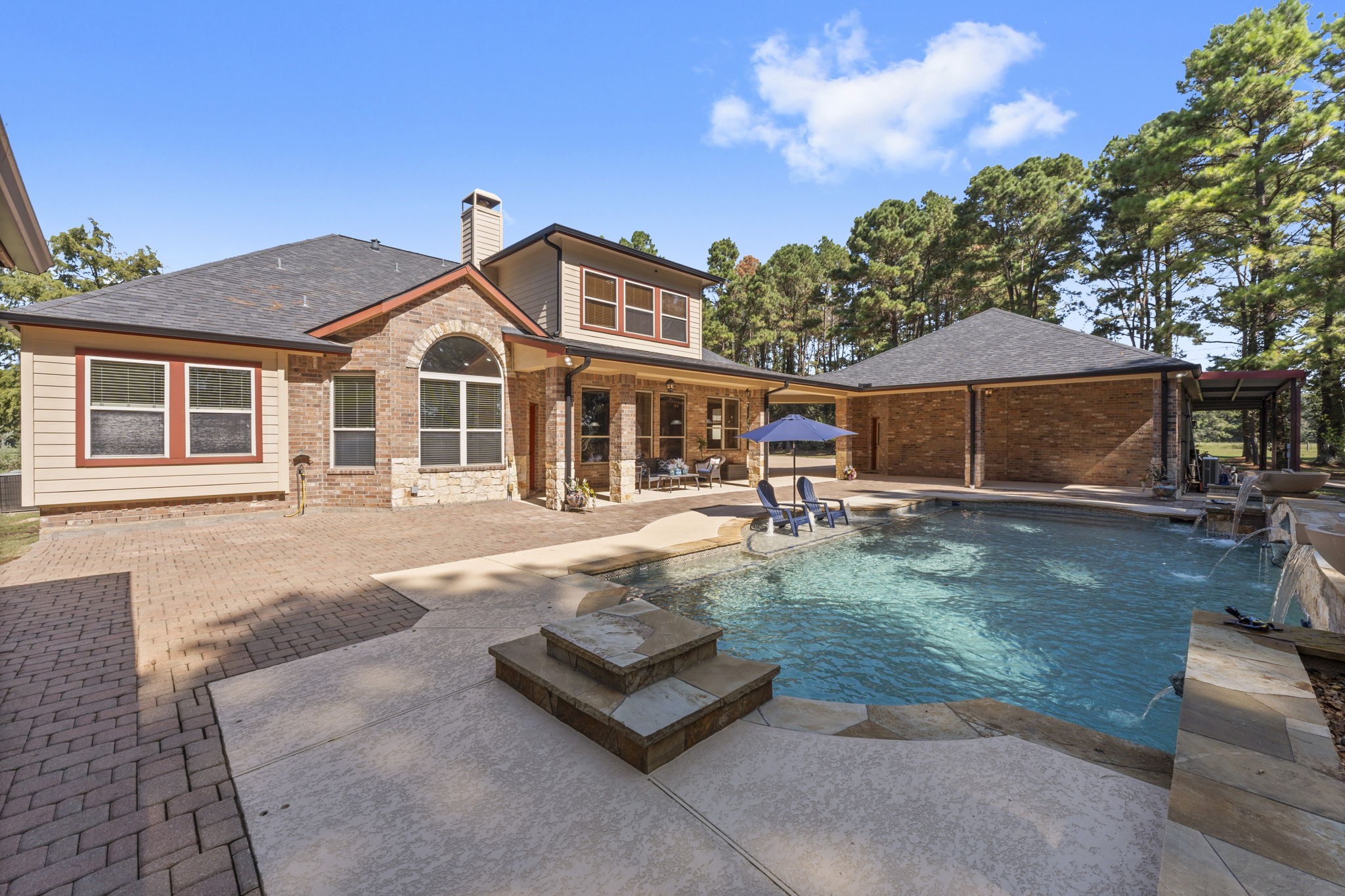1534 Virgie Community Road Magnolia, TX 77354 - Photo 36 of 50 The backyard oasis features a sparkling pool with a soothing waterfall that offers a peaceful atmosphere.