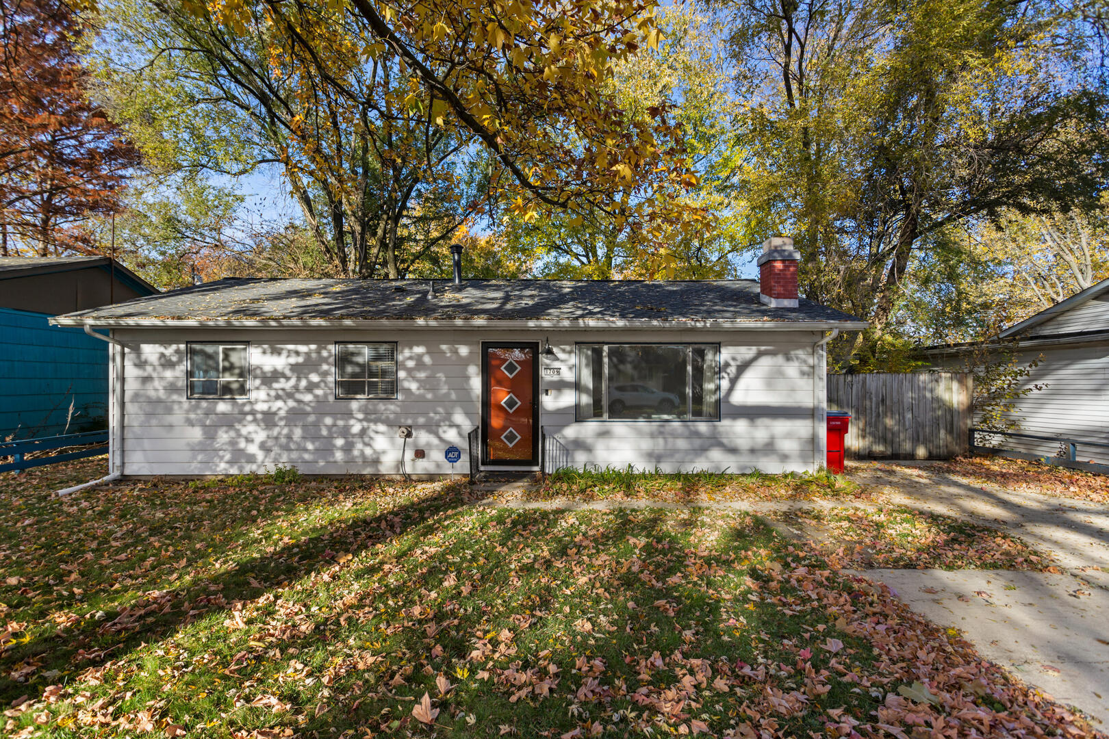 a view of a house with a yard and tree