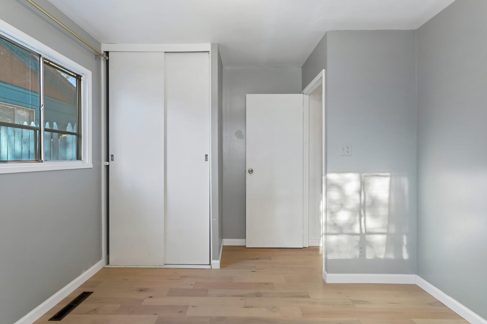 1709 Crescent Drive Champaign, IL 61821 - Photo 16 of 27 an empty room with wooden floor and windows