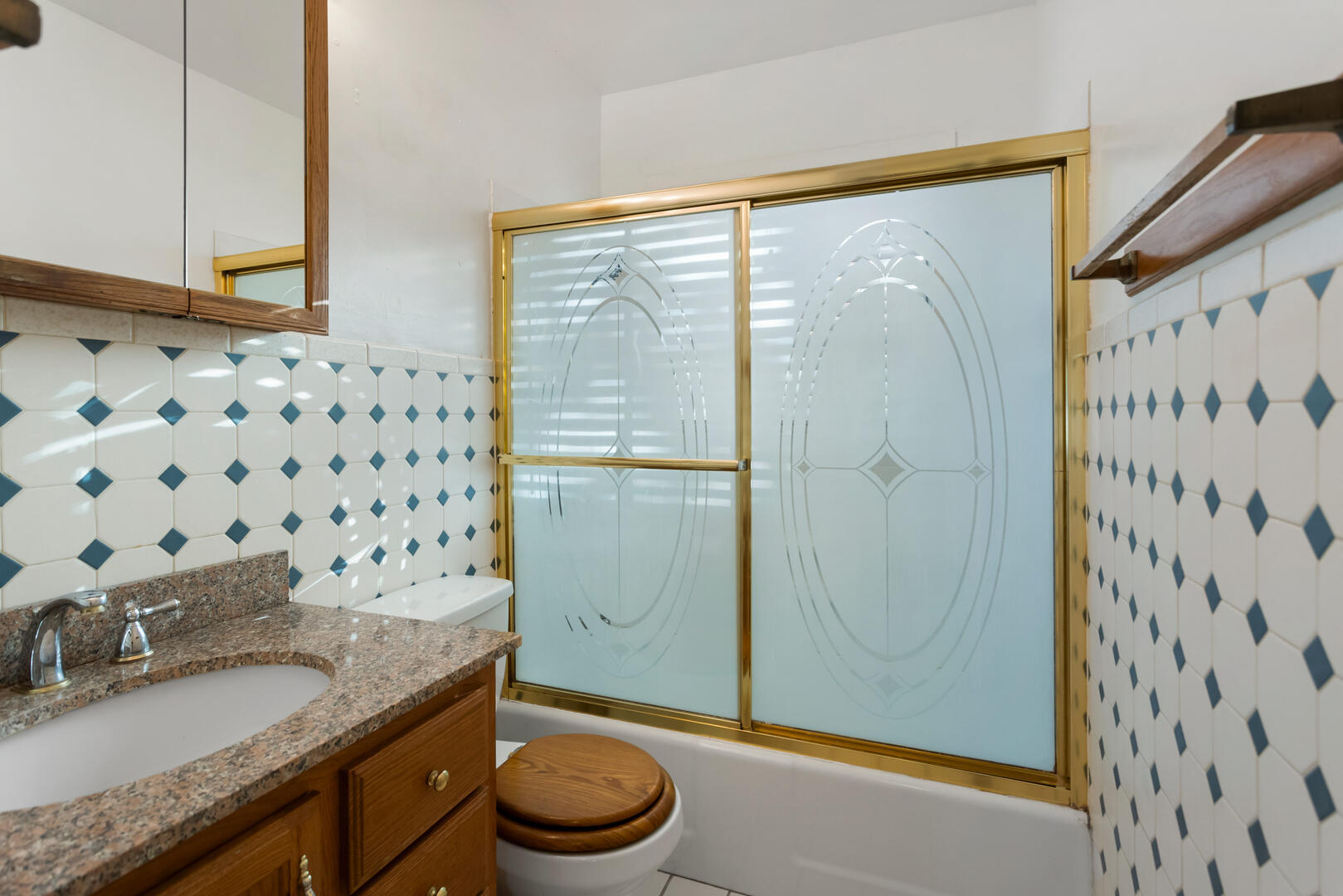 1709 Crescent Drive Champaign, IL 61821 - Photo 17 of 27 a bathroom with a granite countertop sink a toilet and shower