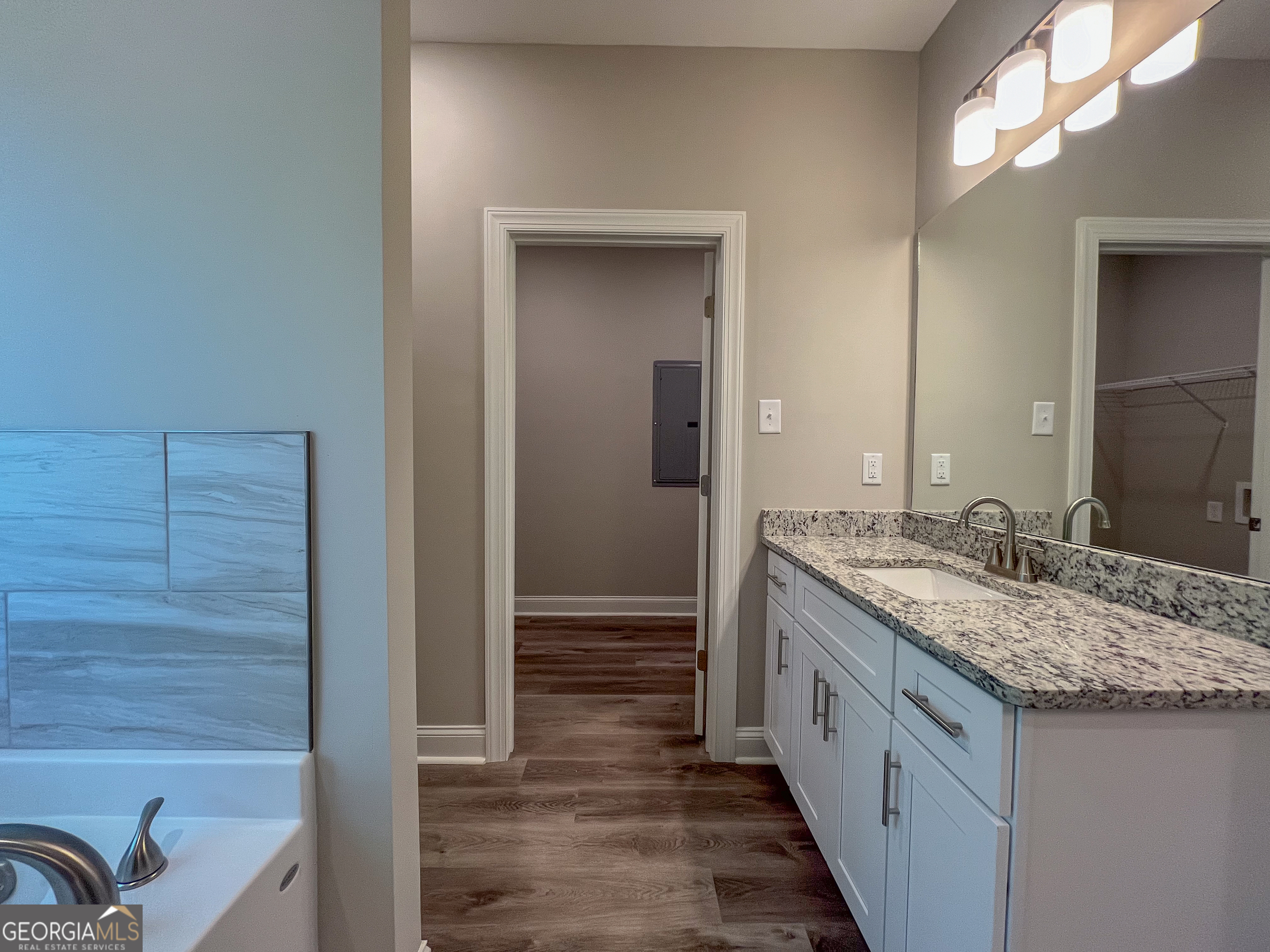 711 Flanders Lane Dublin, GA 31021 - Photo 27 of 49 a bathroom with a granite countertop sink and a mirror