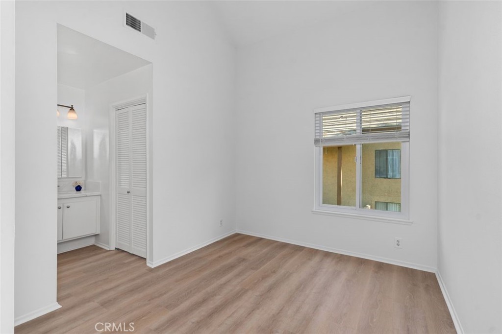 89 Lemon Grove Irvine, CA 92618 - Photo 13 of 34 an empty room with wooden floor and windows