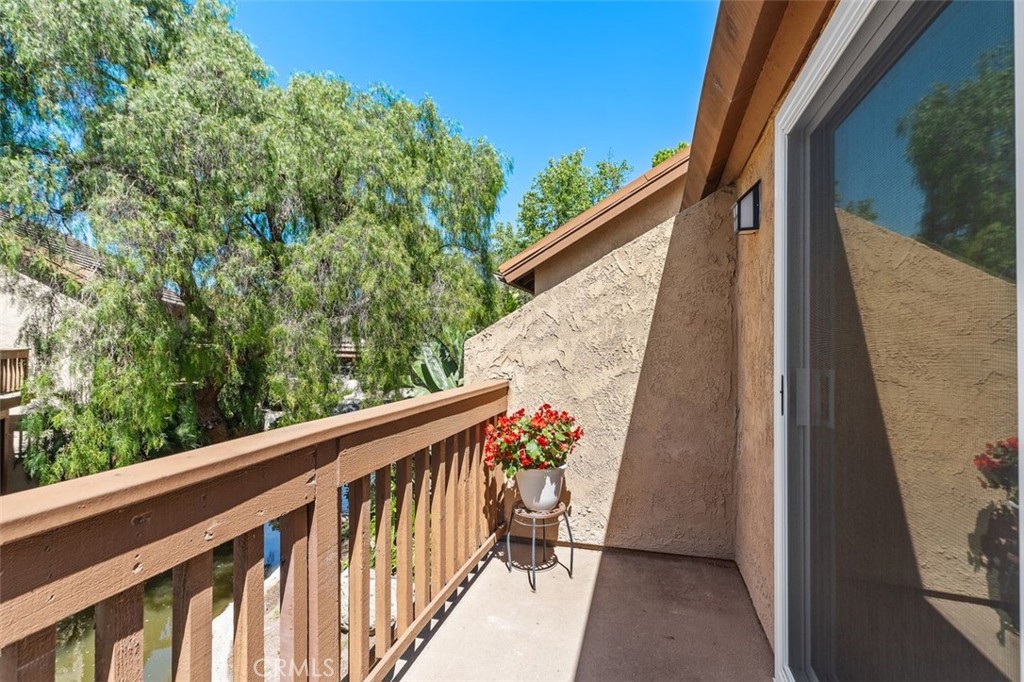 89 Lemon Grove Irvine, CA 92618 - Photo 23 of 34 a view of a balcony with wooden floor and fence