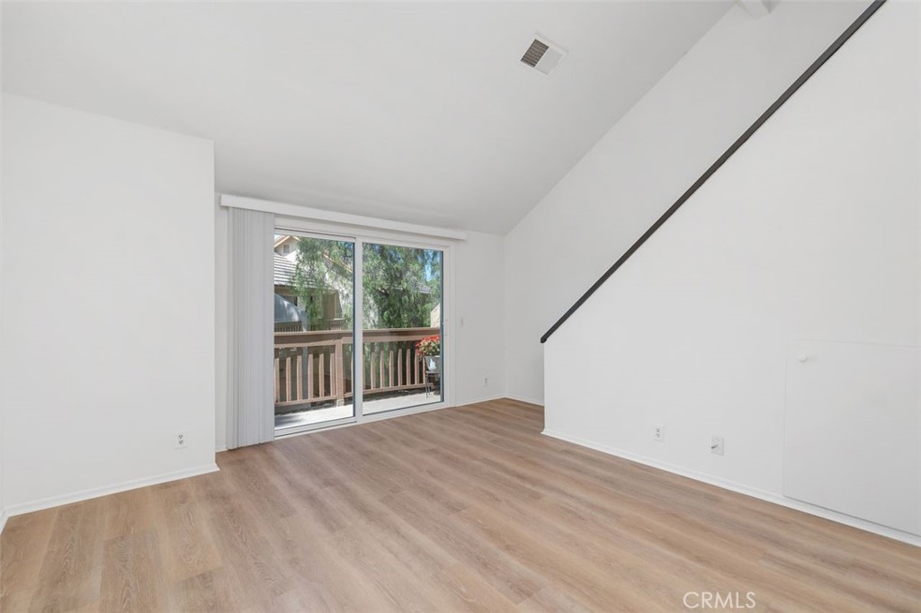 89 Lemon Grove Irvine, CA 92618 - Photo 6 of 34 a view of empty room with wooden floor and fan