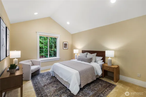 a spacious bedroom with a bed and furniture