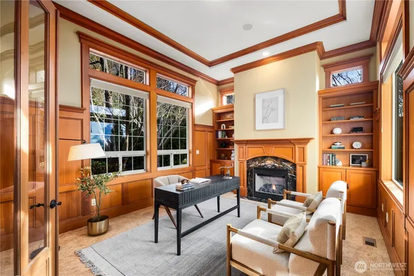 a living room with furniture a fireplace and next to a window