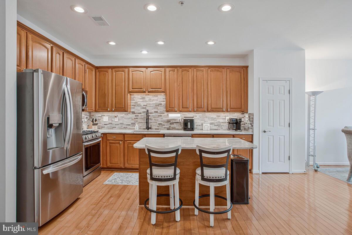 3515 Cromarty Lane Edgewater, MD 21037 - Photo 12 of 53 a kitchen with granite countertop stainless steel appliances a refrigerator and wooden cabinets