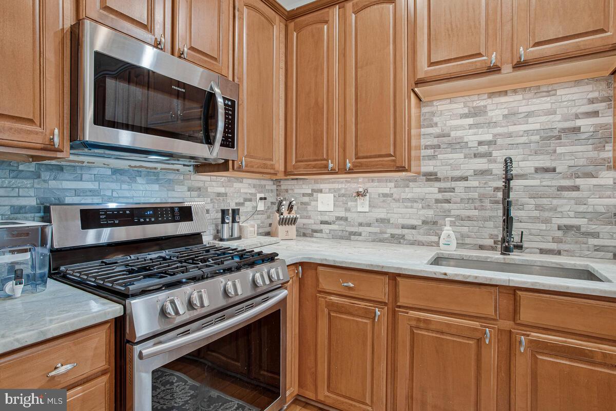 3515 Cromarty Lane Edgewater, MD 21037 - Photo 13 of 53 a kitchen with granite countertop cabinets stainless steel appliances and a sink