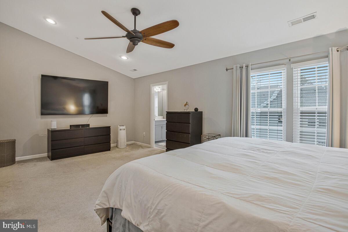 3515 Cromarty Lane Edgewater, MD 21037 - Photo 28 of 53 a bedroom with a bed a flat screen tv and a chandelier