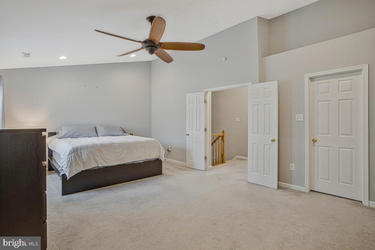 3515 Cromarty Lane Edgewater, MD 21037 - Photo 29 of 53 a spacious bedroom with a bed and a ceiling fan