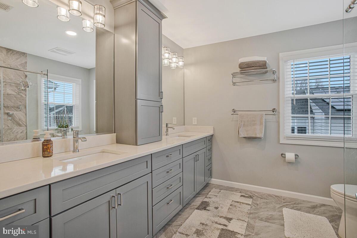 3515 Cromarty Lane Edgewater, MD 21037 - Photo 30 of 53 a bathroom with a double vanity sink toilet and a mirror