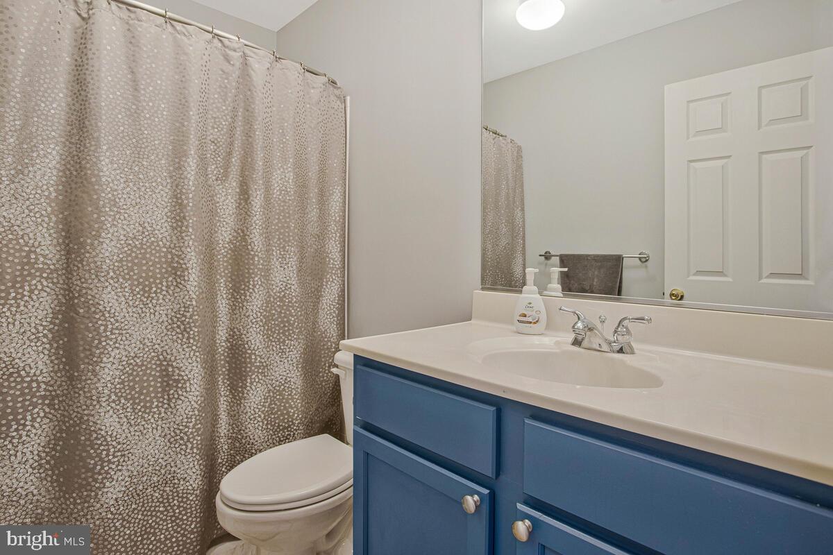 3515 Cromarty Lane Edgewater, MD 21037 - Photo 38 of 53 a bathroom with a sink a toilet a mirror and shower curtain