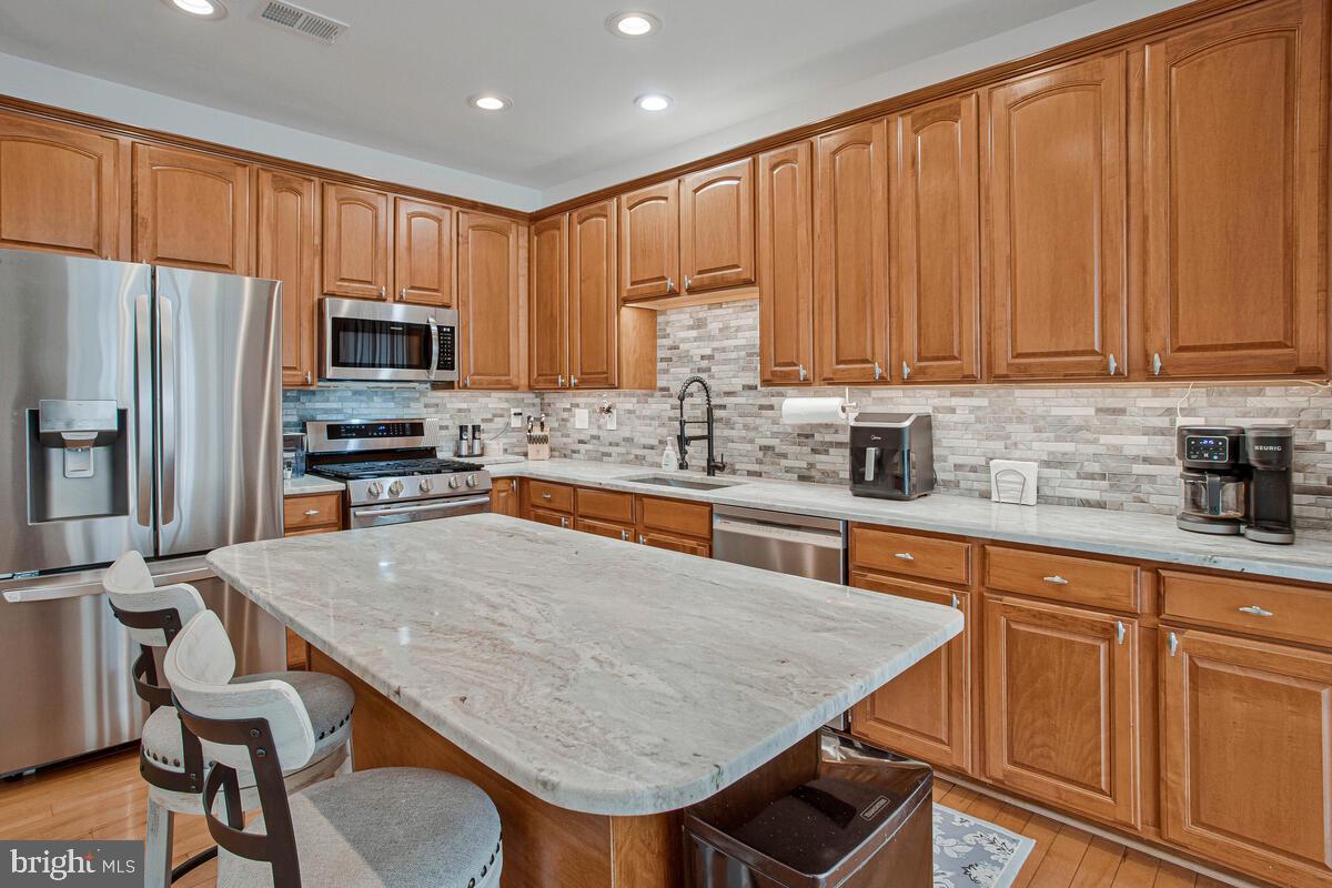 3515 Cromarty Lane Edgewater, MD 21037 - Photo 10 of 53 a kitchen with stainless steel appliances granite countertop a stove refrigerator sink microwave and cabinets
