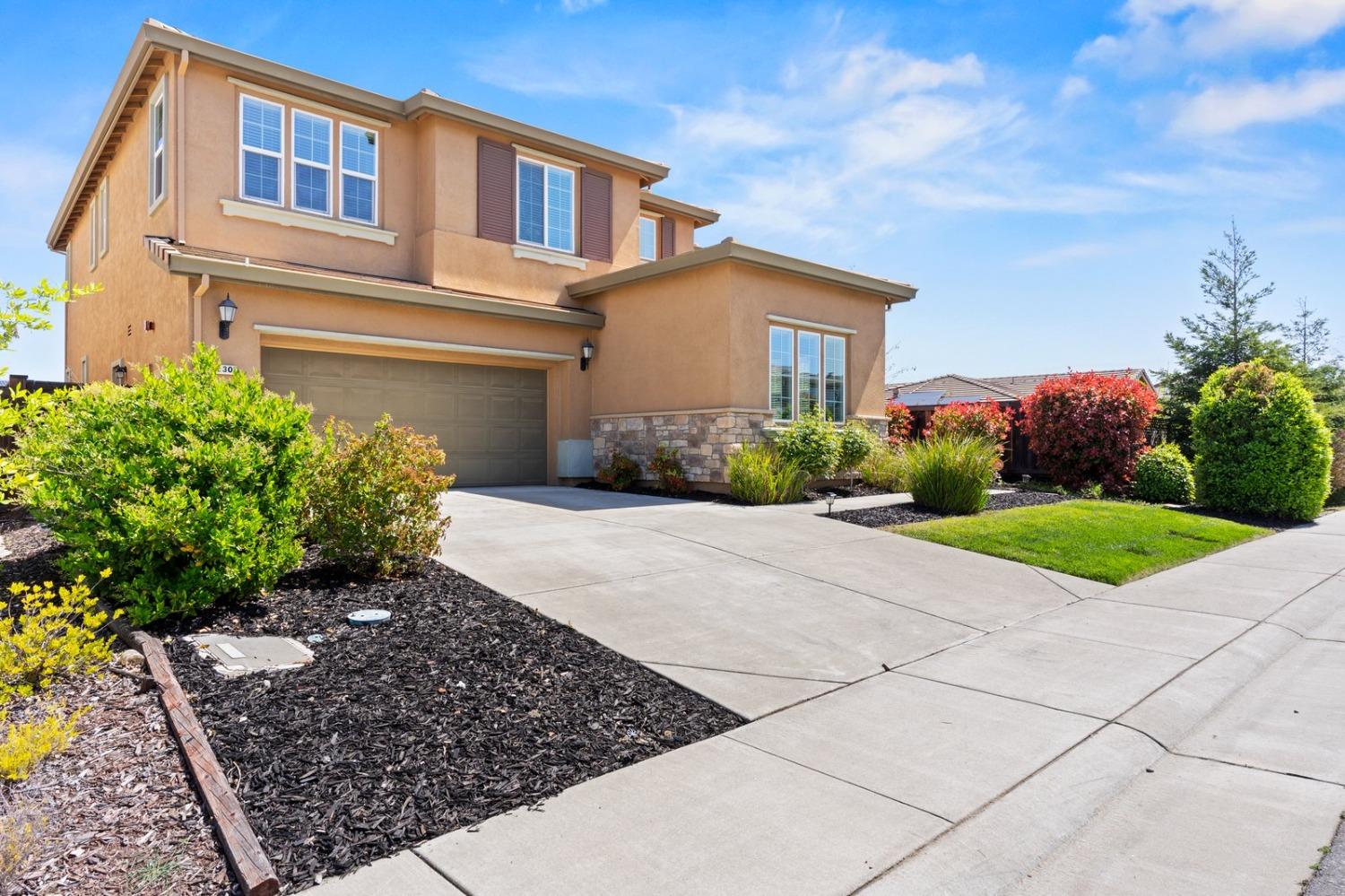 6307 Lookout Pass Way Rocklin, CA 95765 - Photo 2 of 72 a front view of a house with a yard and potted plants