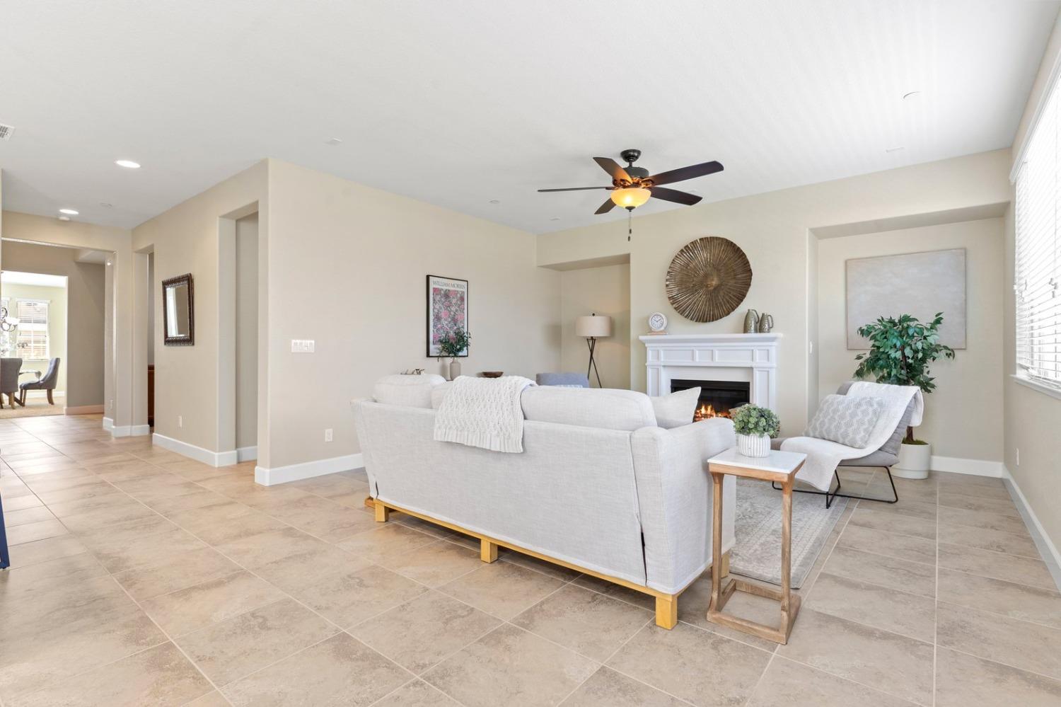 6307 Lookout Pass Way Rocklin, CA 95765 - Photo 29 of 72 a living room with furniture a fireplace and a large window