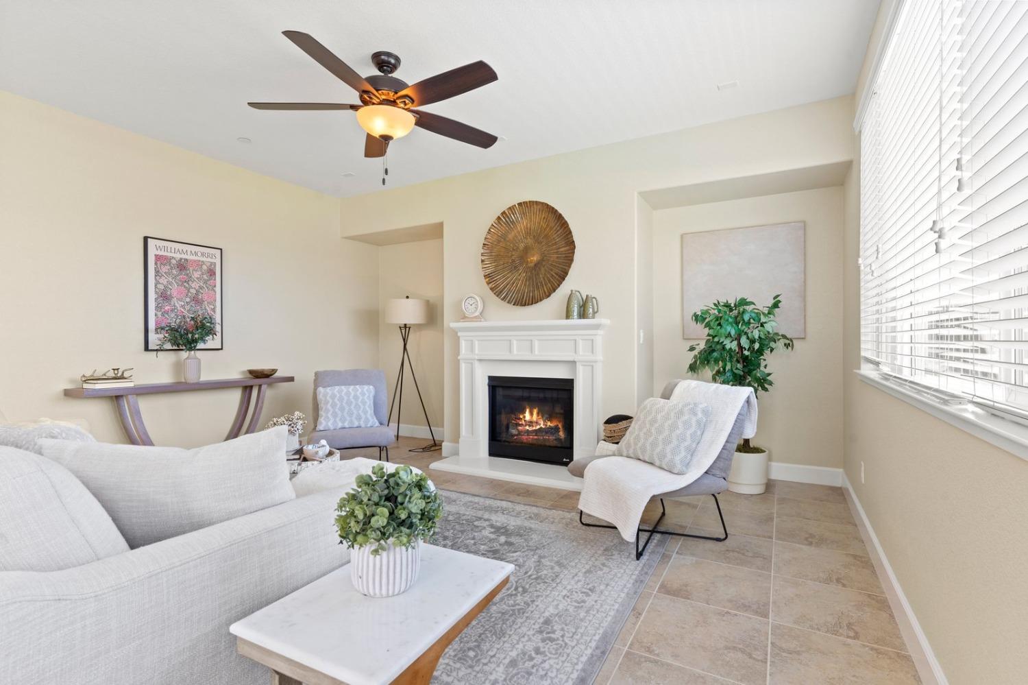 6307 Lookout Pass Way Rocklin, CA 95765 - Photo 30 of 72 a living room with furniture a fireplace and a large window