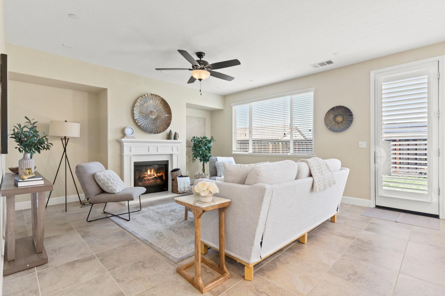 6307 Lookout Pass Way Rocklin, CA 95765 - Photo 31 of 72 a living room with furniture a clock and a fireplace