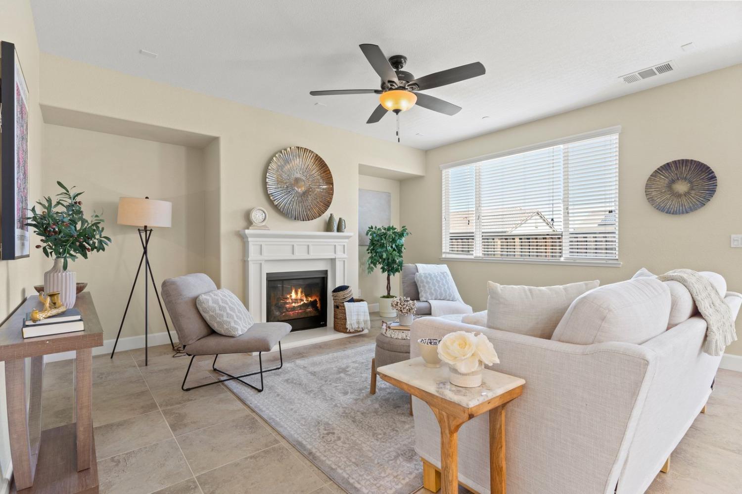 6307 Lookout Pass Way Rocklin, CA 95765 - Photo 32 of 72 a living room with furniture a fireplace and a large window