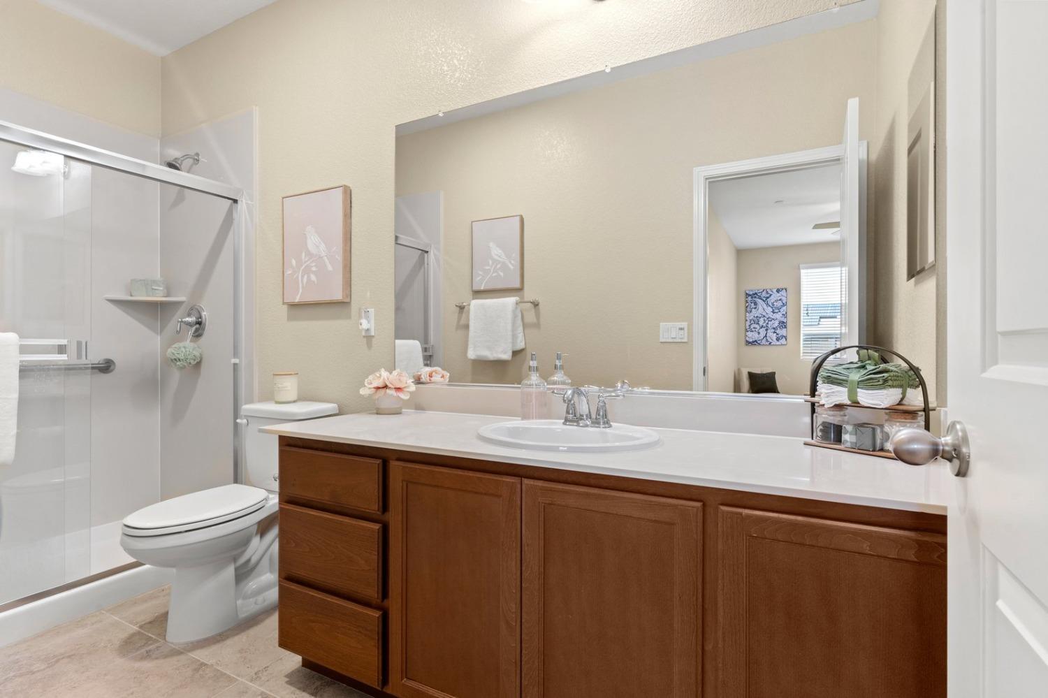 6307 Lookout Pass Way Rocklin, CA 95765 - Photo 35 of 72 a bathroom with a double vanity sink toilet and a mirror