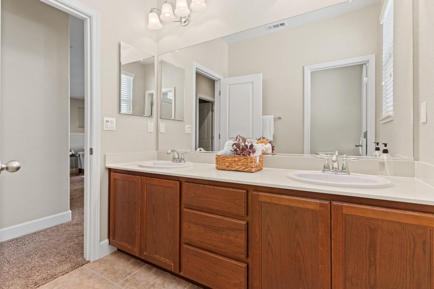 6307 Lookout Pass Way Rocklin, CA 95765 - Photo 45 of 72 a bathroom with double sink and a mirror