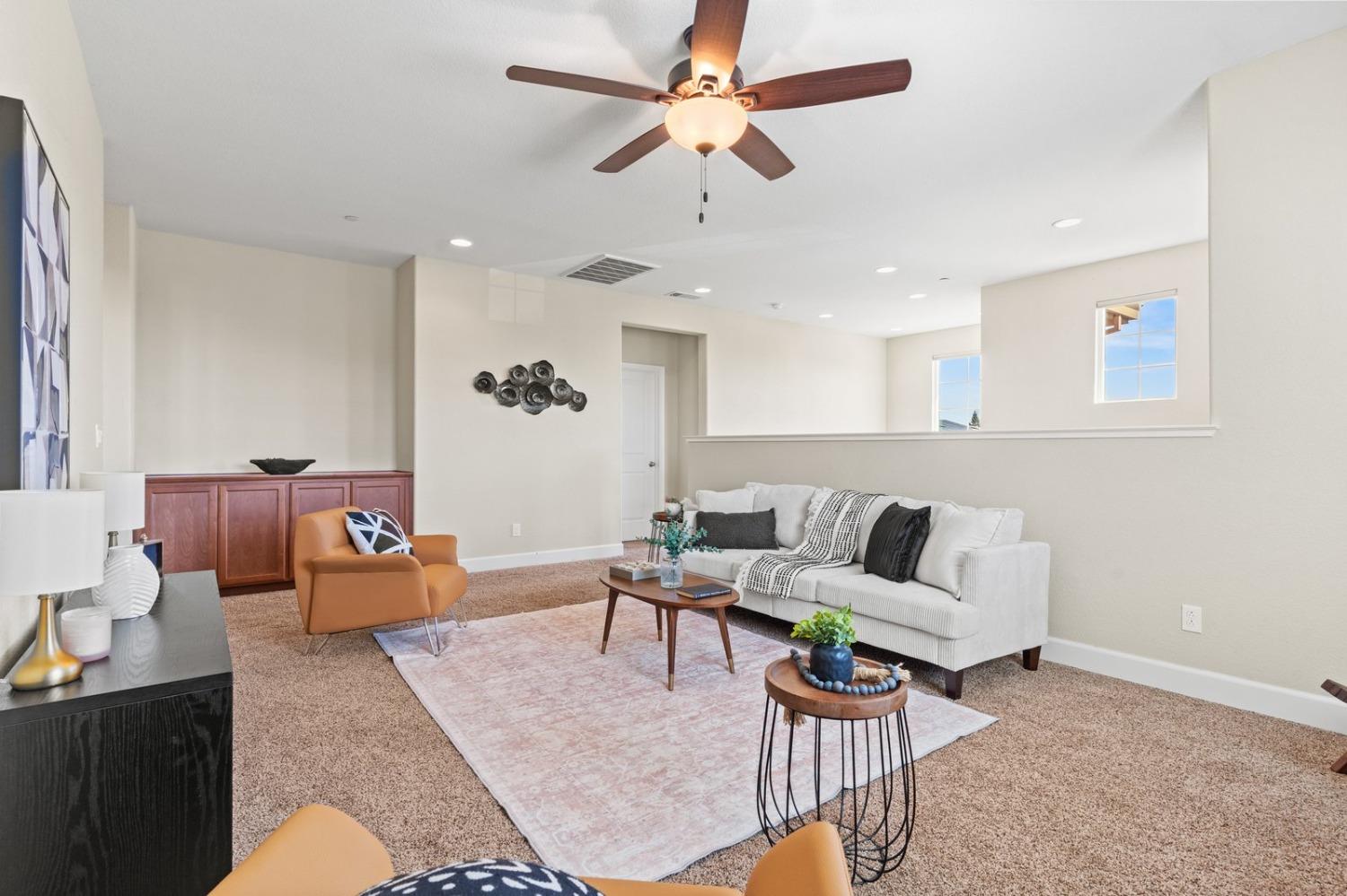 6307 Lookout Pass Way Rocklin, CA 95765 - Photo 52 of 72 a living room with furniture kitchen view and a chandelier