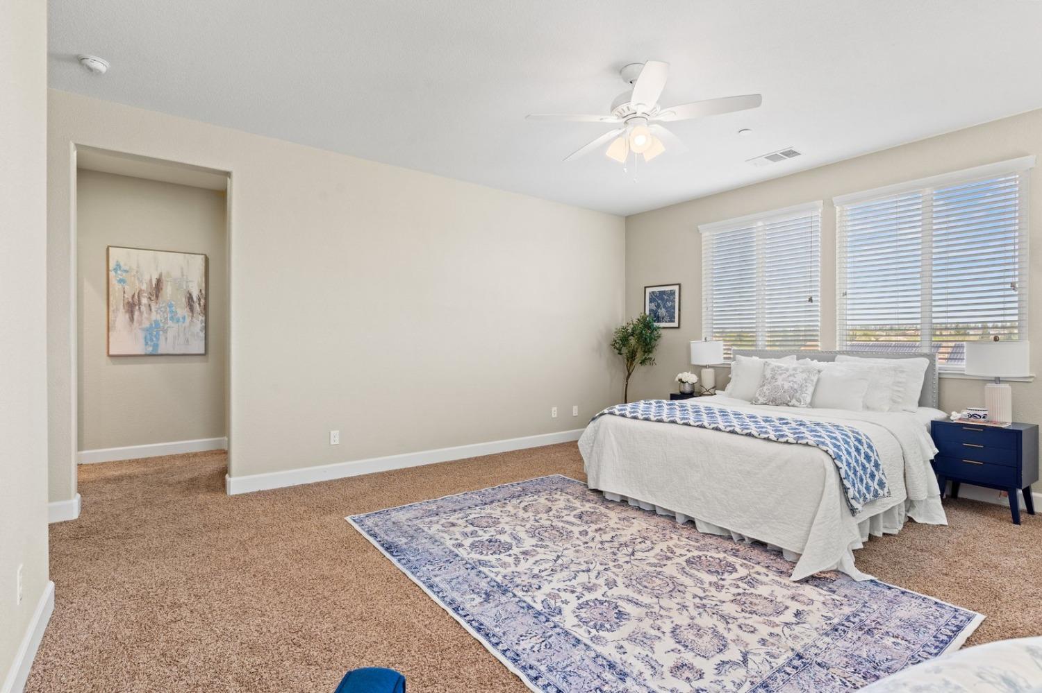 6307 Lookout Pass Way Rocklin, CA 95765 - Photo 58 of 72 a spacious bedroom with a large bed and a chandelier