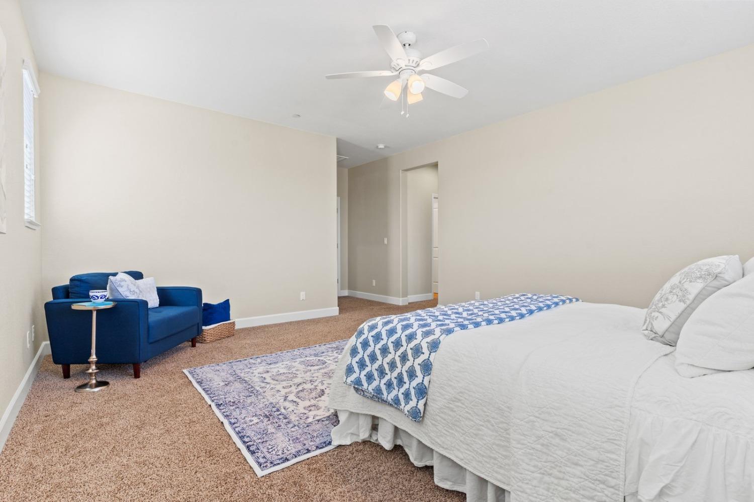 6307 Lookout Pass Way Rocklin, CA 95765 - Photo 60 of 72 a bedroom with a bed and a chandelier