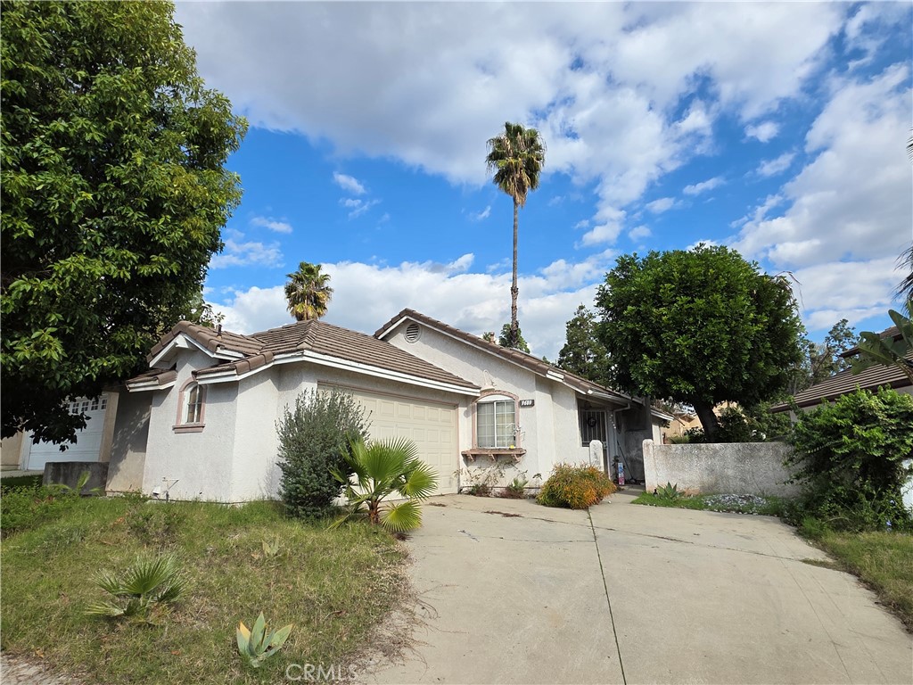 a front view of a house with a garden