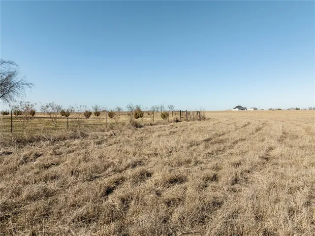 a view of a large building with mountains in the background