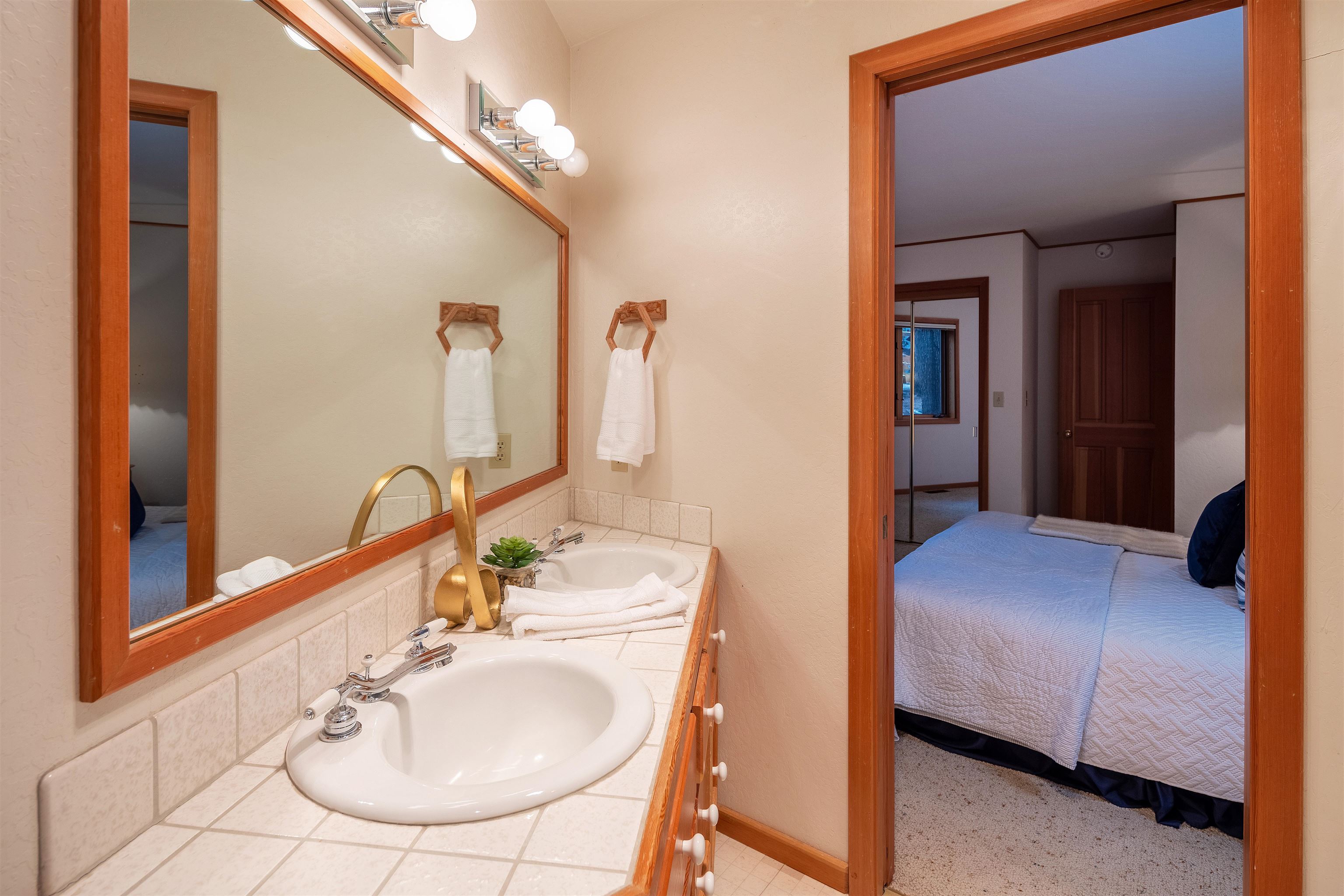 11406 Chalet Road Truckee, CA 96161 - Photo 16 of 21 a en suite bathroom with a double vanity sink and a mirror