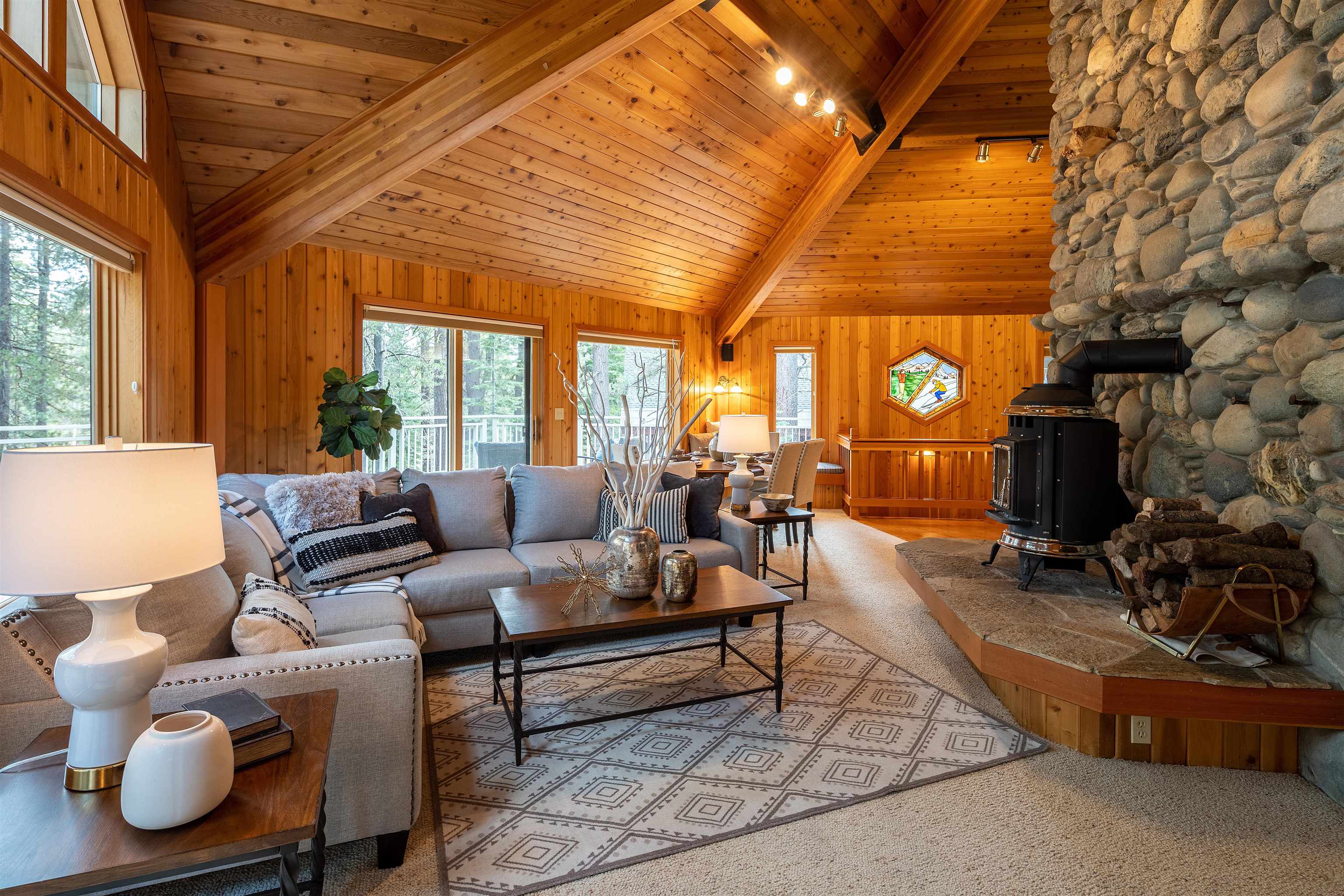 11406 Chalet Road Truckee, CA 96161 - Photo 5 of 21 a living room with furniture a fireplace and a large window