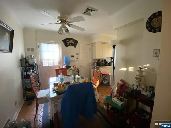 a view of a livingroom with furniture and a ceiling fan