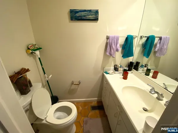 a bathroom with a sink a toilet and a mirror