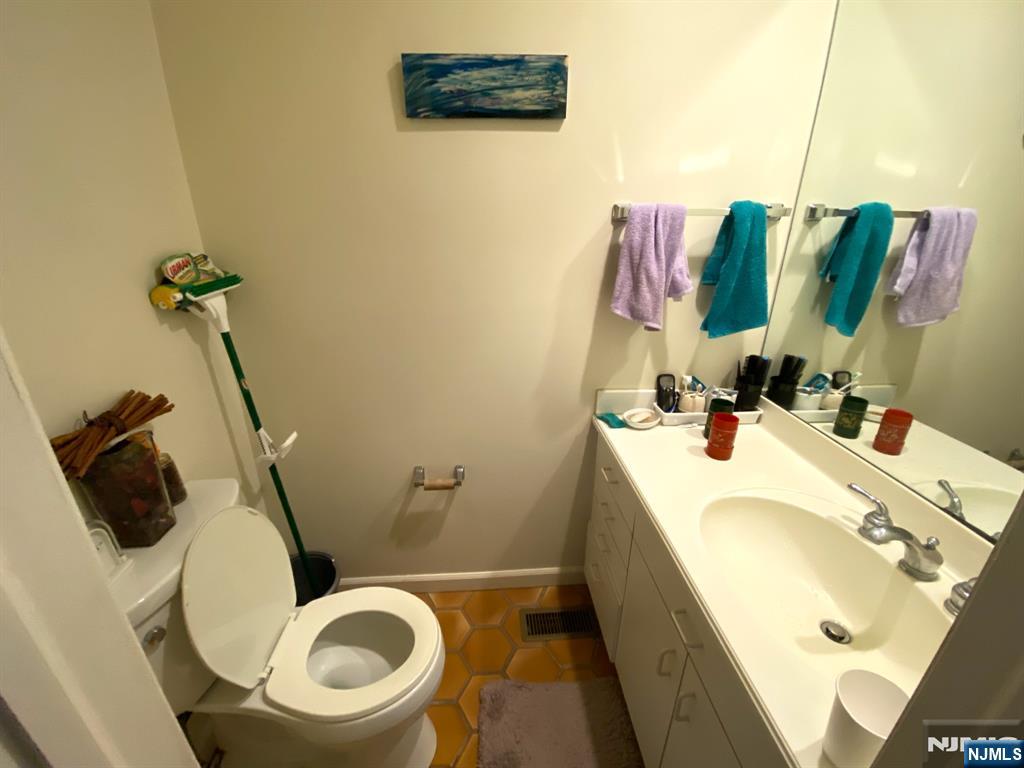 81 5th Street Cresskill, NJ 07626 - Photo 6 of 13 a bathroom with a sink a toilet and a mirror
