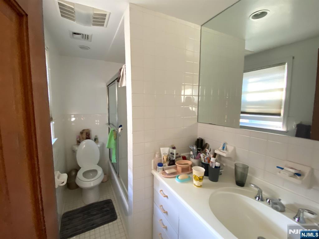 81 5th Street Cresskill, NJ 07626 - Photo 8 of 13 a bathroom with double vanity and a mirror
