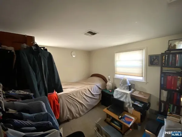 a bedroom with furniture and a window