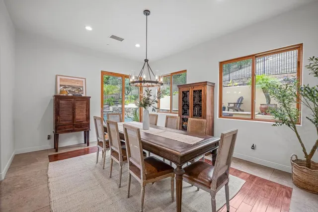 a kitchen with kitchen island granite countertop a sink counter top space appliances and a large window