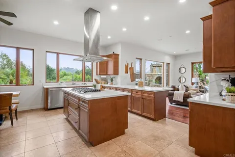 a kitchen with a sink window and cabinets